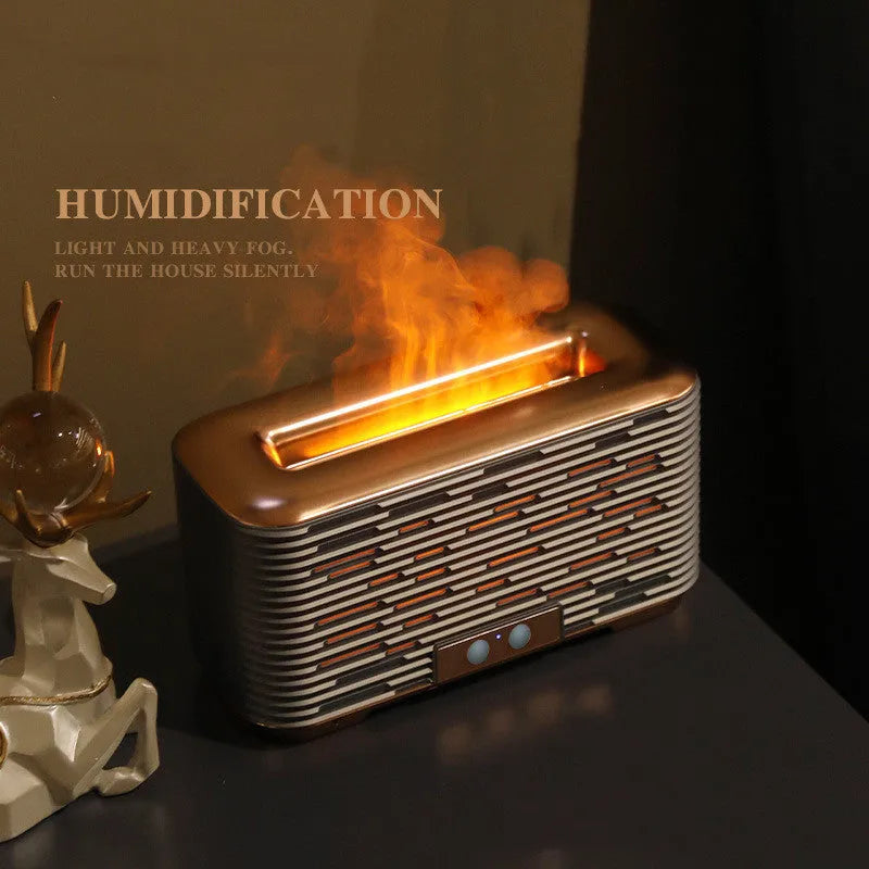 Flame aroma diffuser humidifier in gold with double-colour atmosphere light on a desktop