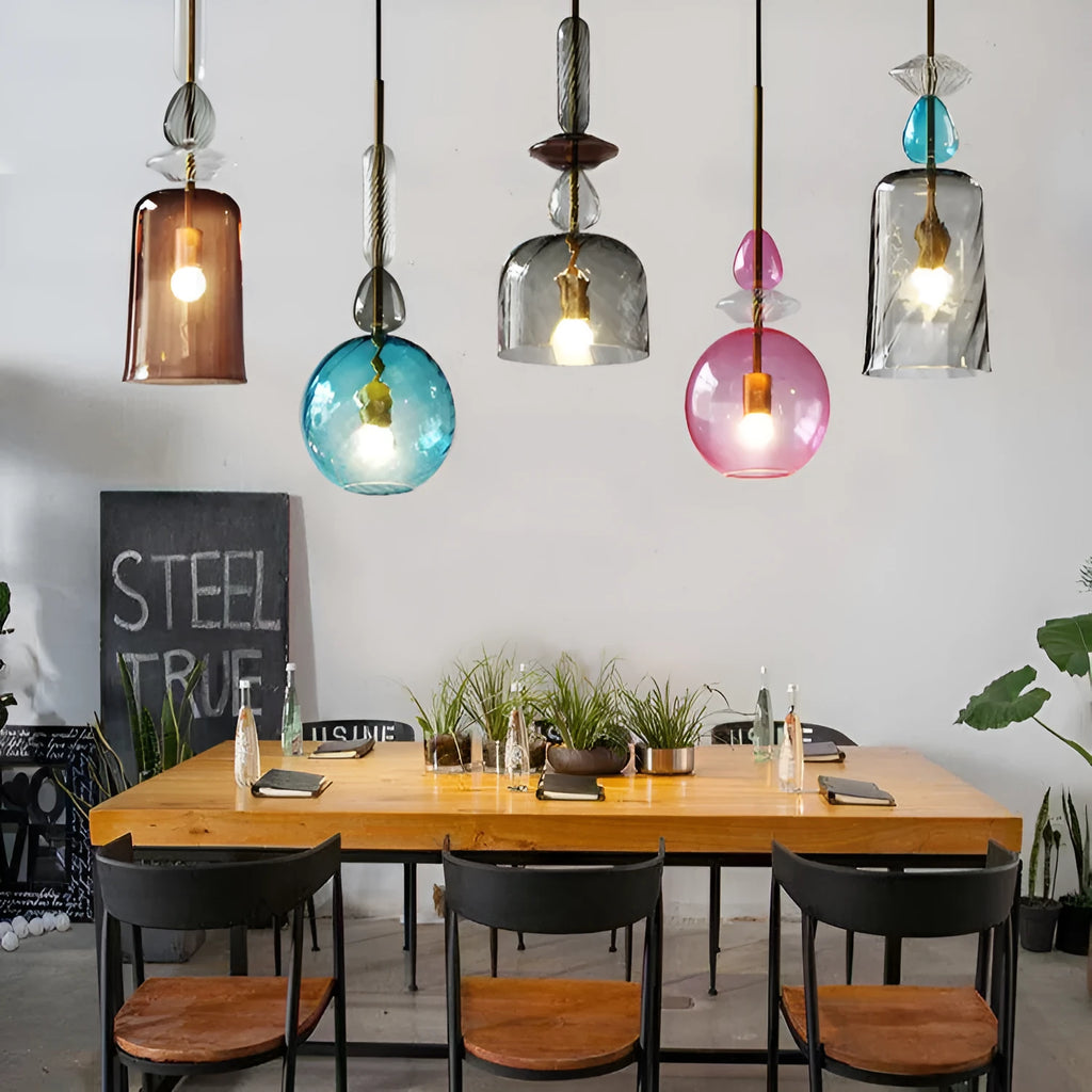 Glass and crystal adjustable chandelier hanging over a bar counter with LED lights.