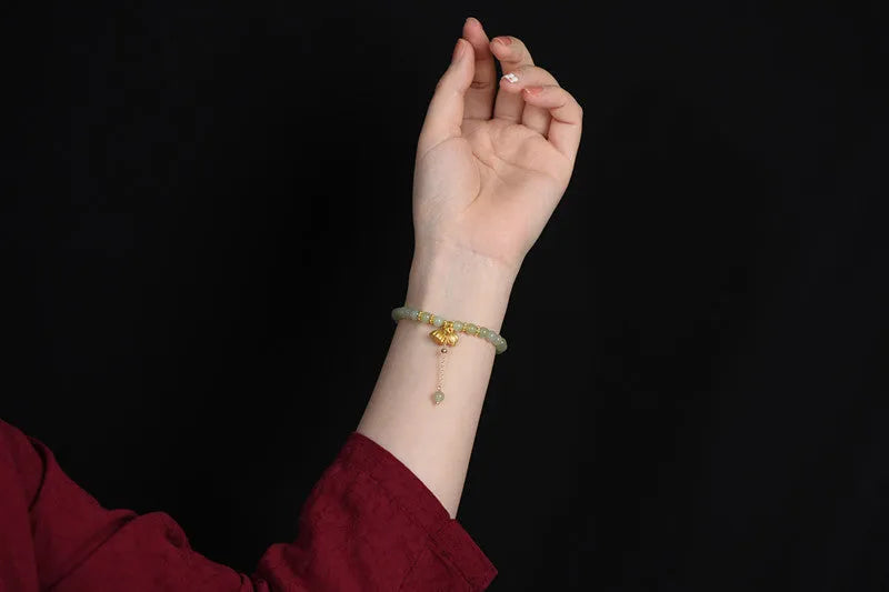 Natural Hetian Jade bracelet with Fu character detail on 6mm beads in a sunny water colour.
