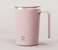 White automatic electric mixing cup with USB cable on a table.