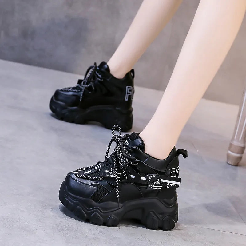 White women's low-top platform sports shoes with cross-strap and round toe on a rubber sole.