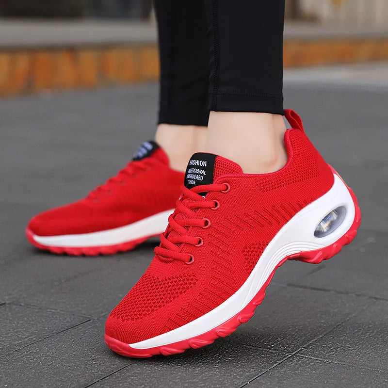 Black and red women's low-top mesh sneakers with round toe and lace-up front.