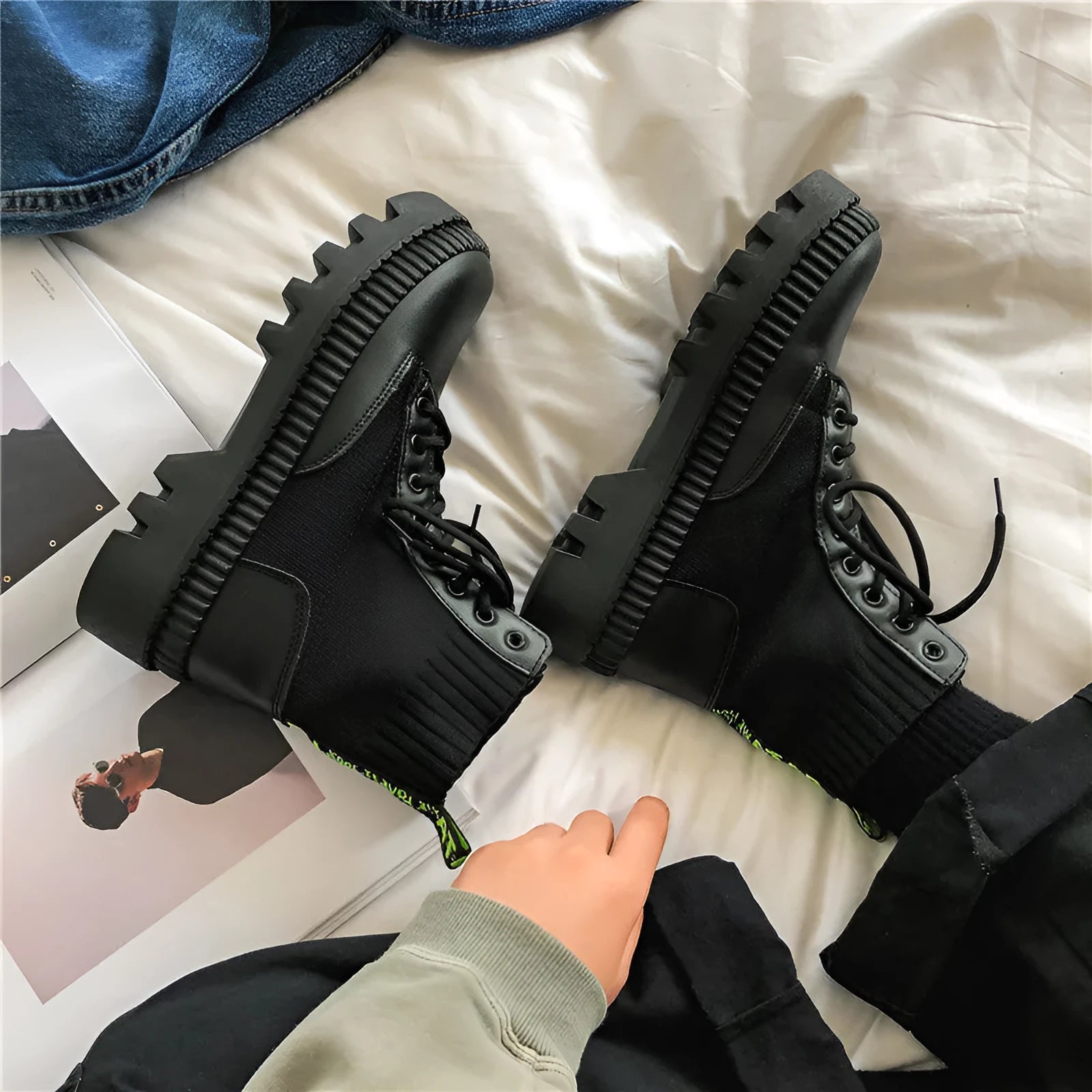 Black frosted leather Dr Martens boots with white laces and a side zipper on a high-top 8-hole design.