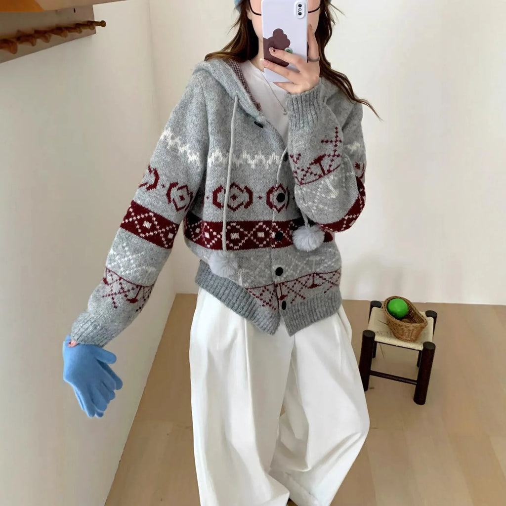 Loose fit grey geometric brocade sweater coat for plus size women on a hanger.