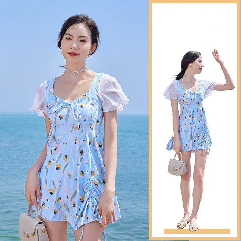 Women's sea salt blue floral one-piece polyester swimsuit on a hanger.