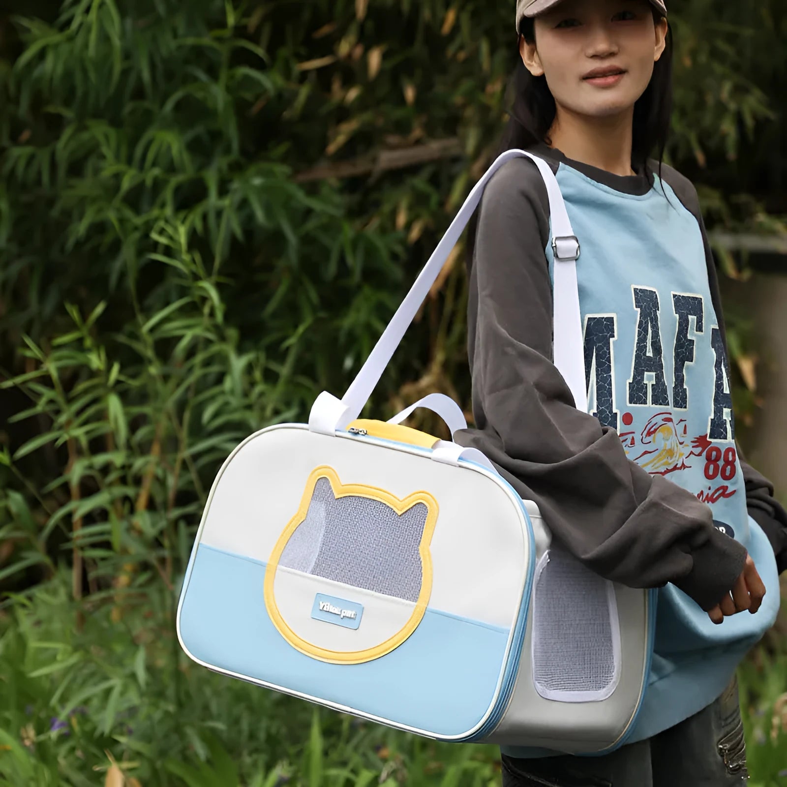 Blue foldable cat carrier backpack showing side view and shoulder straps.