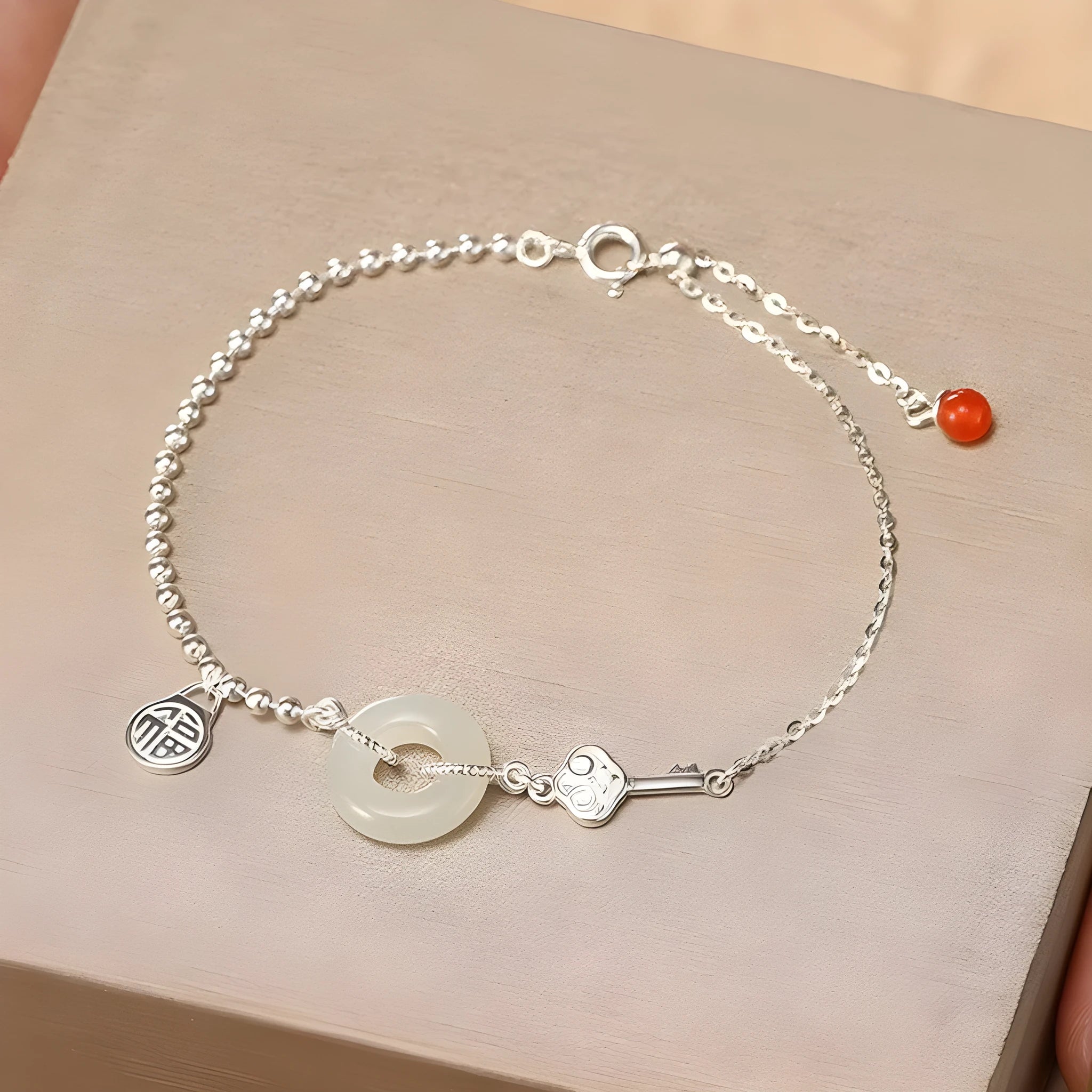 Silver bracelet with geometric peace buckle charm containing Hetian jade, traditional Chinese women's jewellery