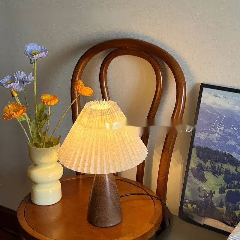 Nordic style ceramic table lamp with a pleated fabric shade on a bedside table