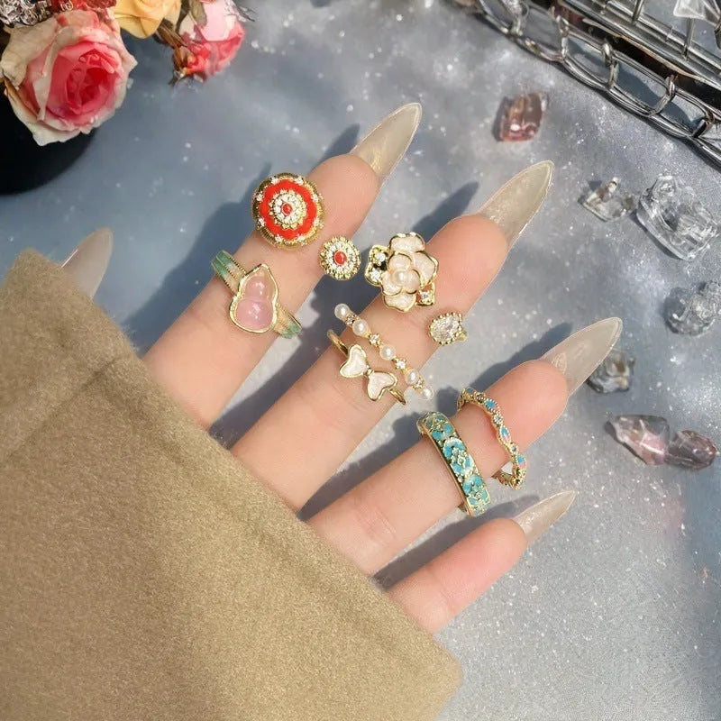 Adjustable vintage-style copper ring with inlaid zircon stones, featuring gourd, flower, and bow shapes.