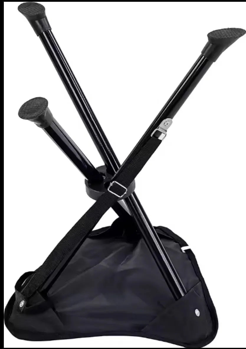 Green folding 3-leg camping stool on grass, lightweight tripod design for outdoor seating