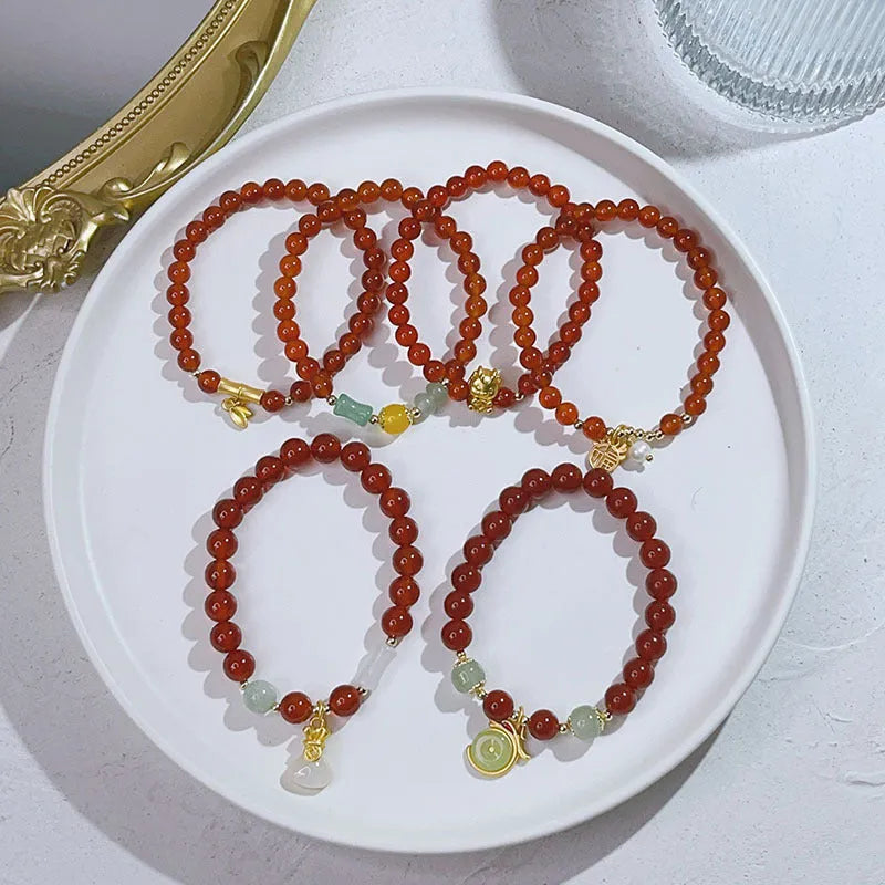 Close-up of a handmade red agate bracelet for women with a traditional Chinese dragon design.