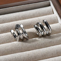 Pair of geometric ear studs for women with sterling silver needles and copper body in gold or silver