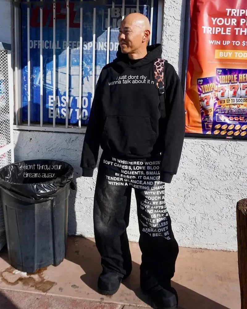 Man wearing loose fit black wide leg cotton casual trousers