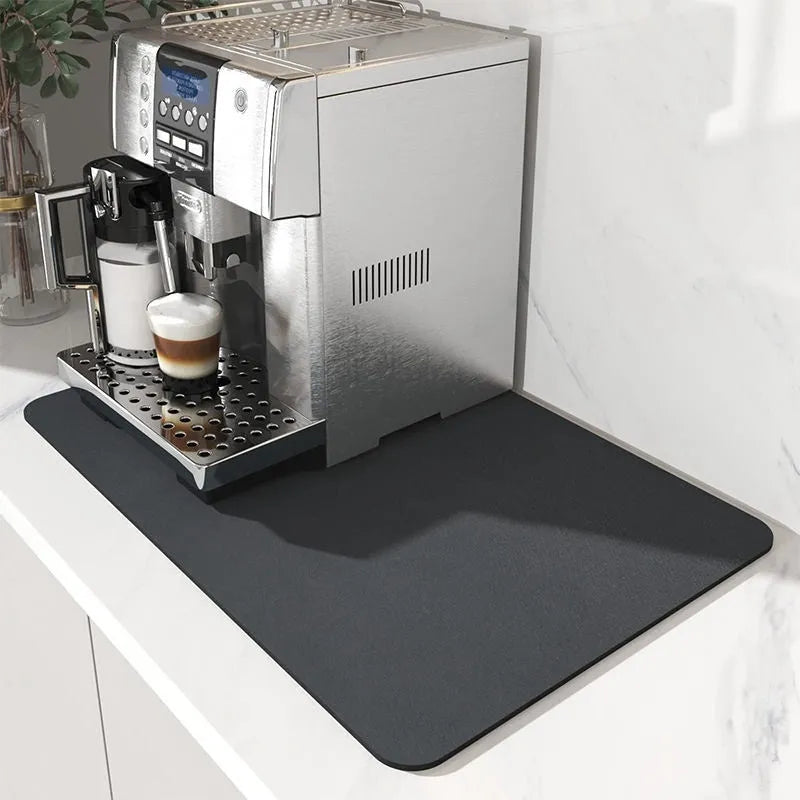 Square super absorbent drain mat with rubber backing in black or blue on a kitchen counter.
