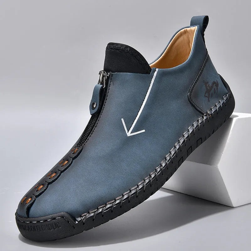 Men's black leather zip-up martin boots with round toe and low heel on a rubber sole.