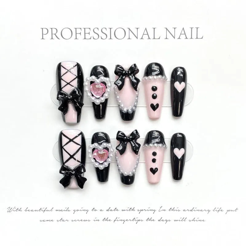 Black and pink heart-shaped hand-painted press-on artificial nails in cat's eye style