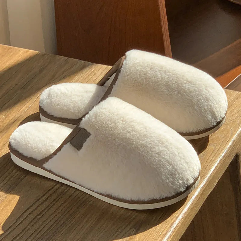 Blue unisex winter plush PVC house slippers with car stitching and a non-slip sole.