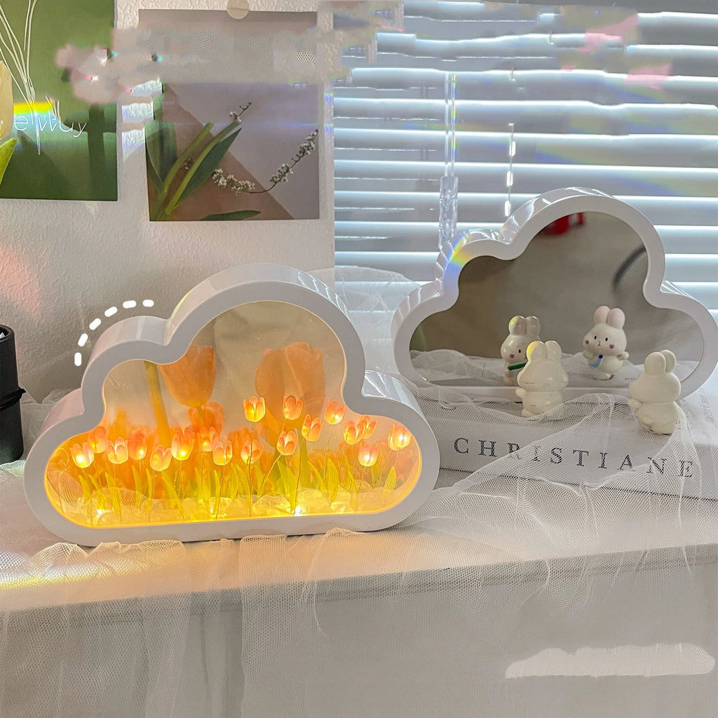 Assembled pink tulip-shaped night lamp with LED light, mirror front, and small photo frame on a desk.