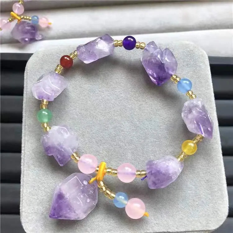 Purple natural shaped amethyst bead bracelet for women with a fu character charm.