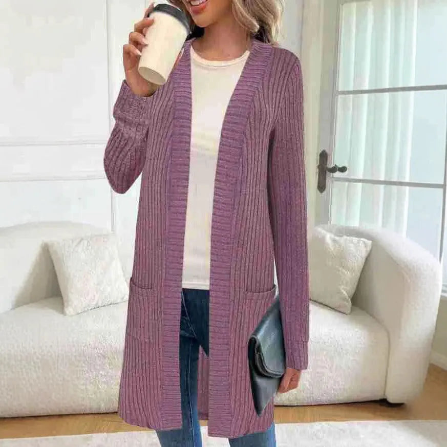 Long sleeve loose knitted cardigan jacket in black, shown with side pockets.
