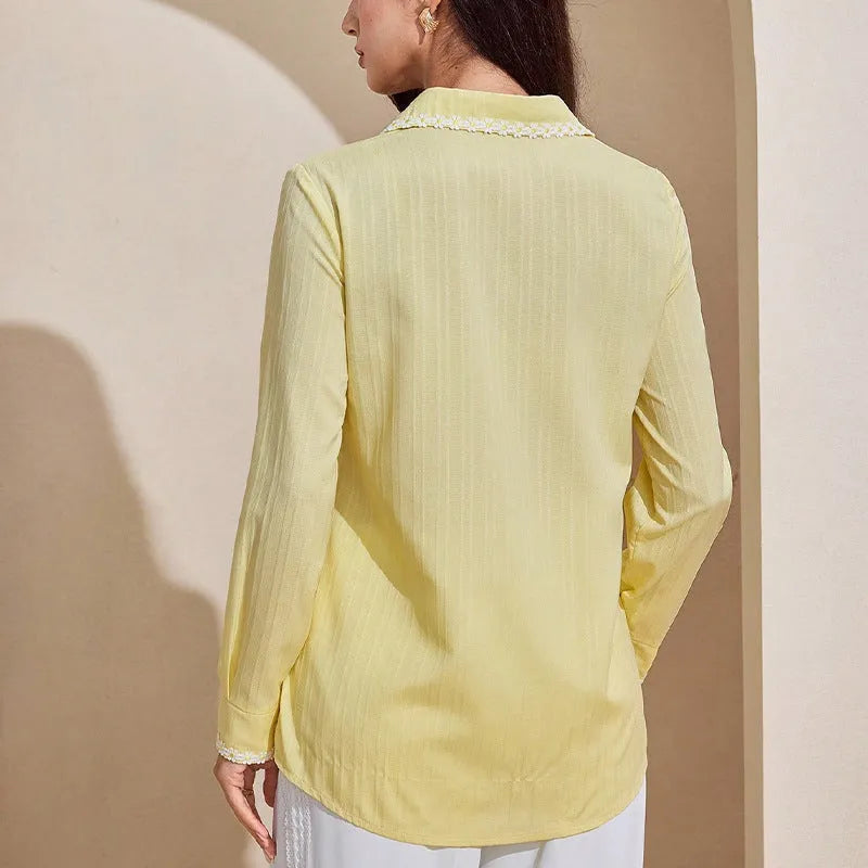 Women's solid yellow lace long-sleeved cardigan top with stitching detail on a plain background