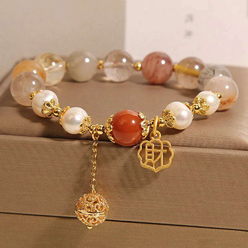 Women's crystal bracelet with colourful hair crystal beads, four pearls, and a Chinese Cai charm.