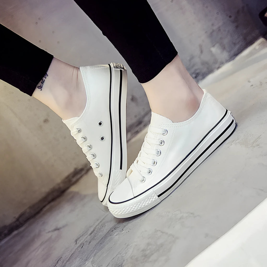 Women's solid colour casual canvas shoes in a lace-up style on a white background.