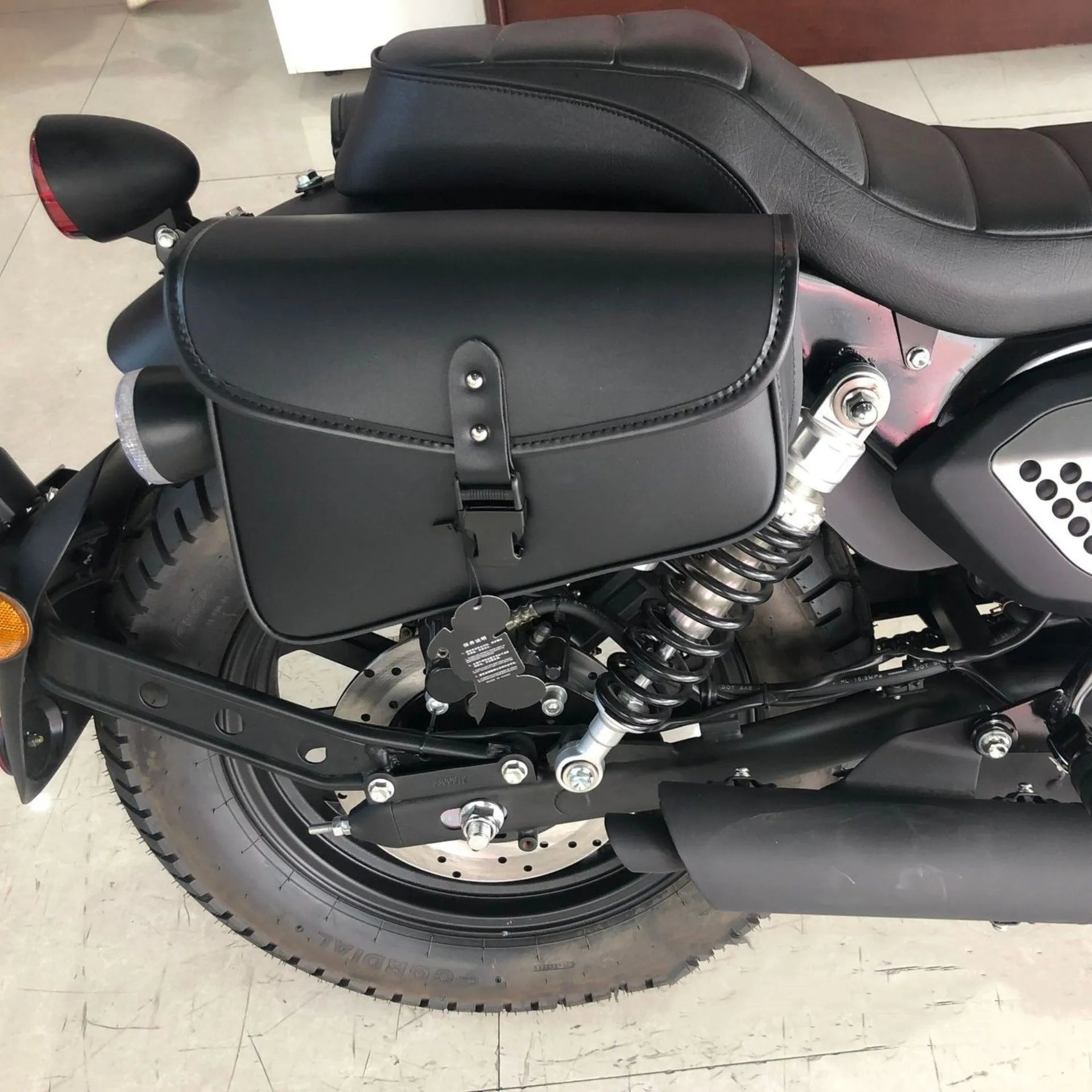 Black PU leather motorcycle swingarm saddlebag mounted on Sportster showing dimensions and mounting position