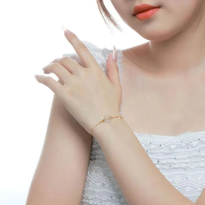 Women's silver bracelet with peace buckle clasp and white chalcedony gemstones in gold finish