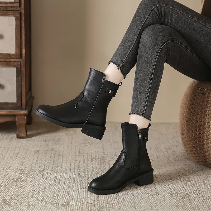 Black women's ankle boots with a side zip, round toe, and a low rubber sole.