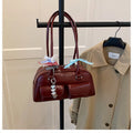 Retro pillow-shaped women's handbag in PU leather with a one shoulder strap, shown in a choice of colours.