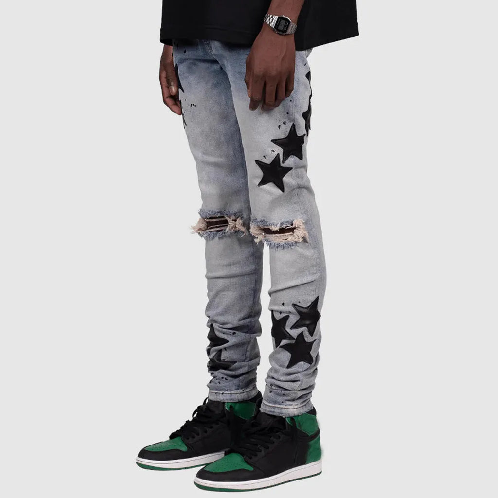 Men's slim blue jeans with embroidery detail on the leg, showing a mid-waist fit.