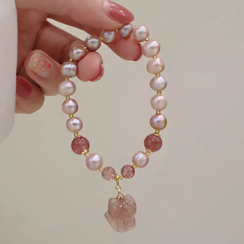 Women's light pink freshwater pearl bracelet with fox charm and strawberry quartz stones