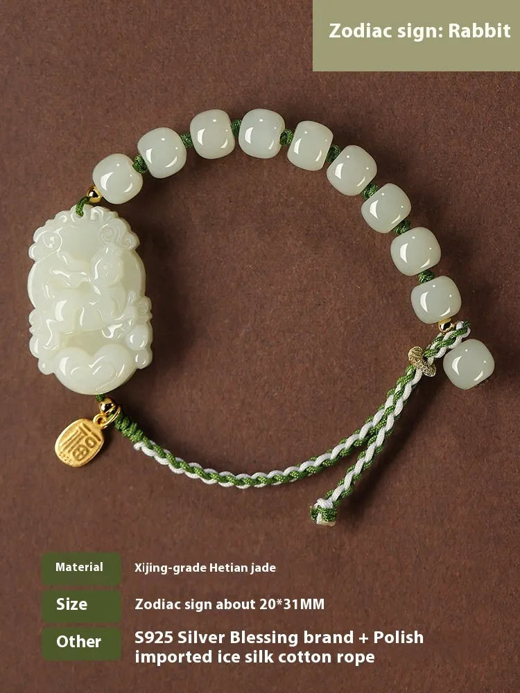 Year of Rabbit red rope bracelet with Hetian jade bead and S925 silver card on a white background.
