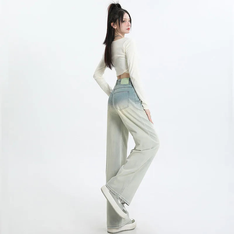 Gradient blue straight-leg women's jeans on a neutral background showing the colour transition.