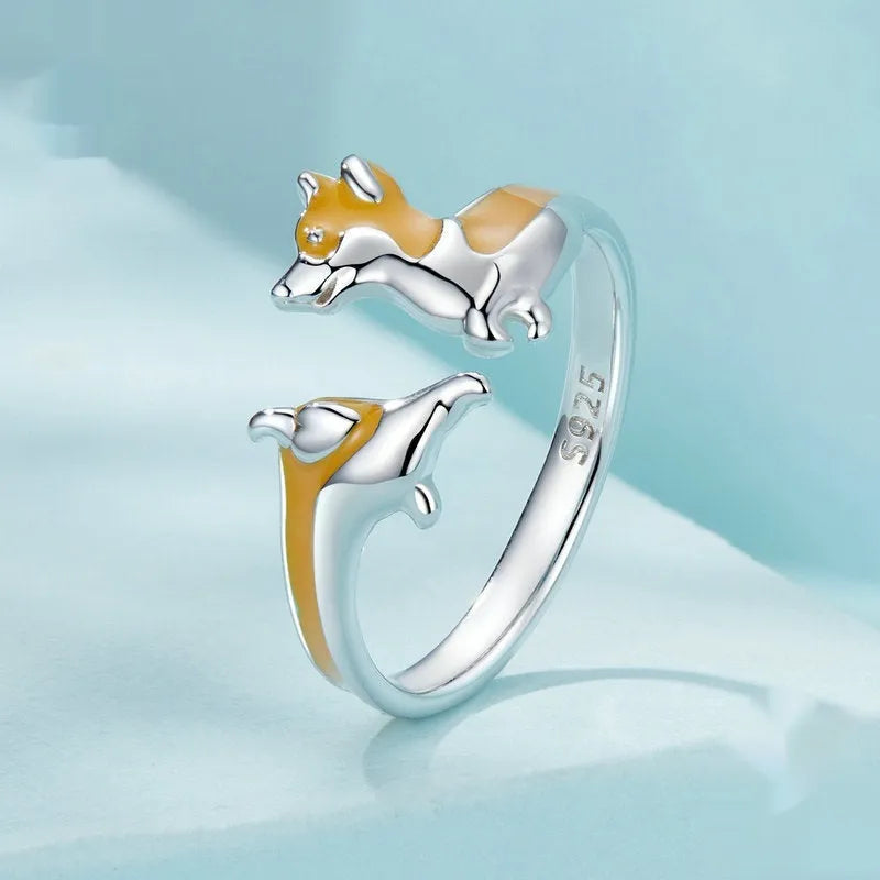 Silver-coloured adjustable ring featuring a raised cartoon corgi dog design, model SCR1014-E.