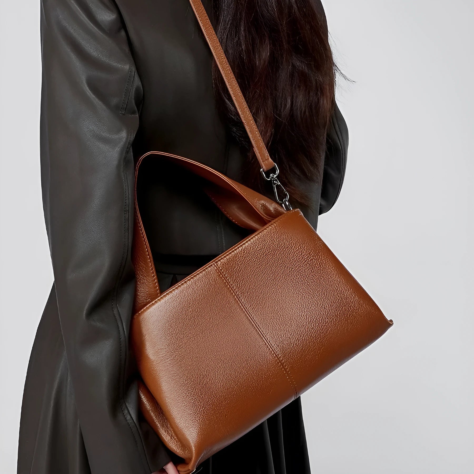 Women's brown retro texture leather messenger bag with a double shoulder strap shown on a table.