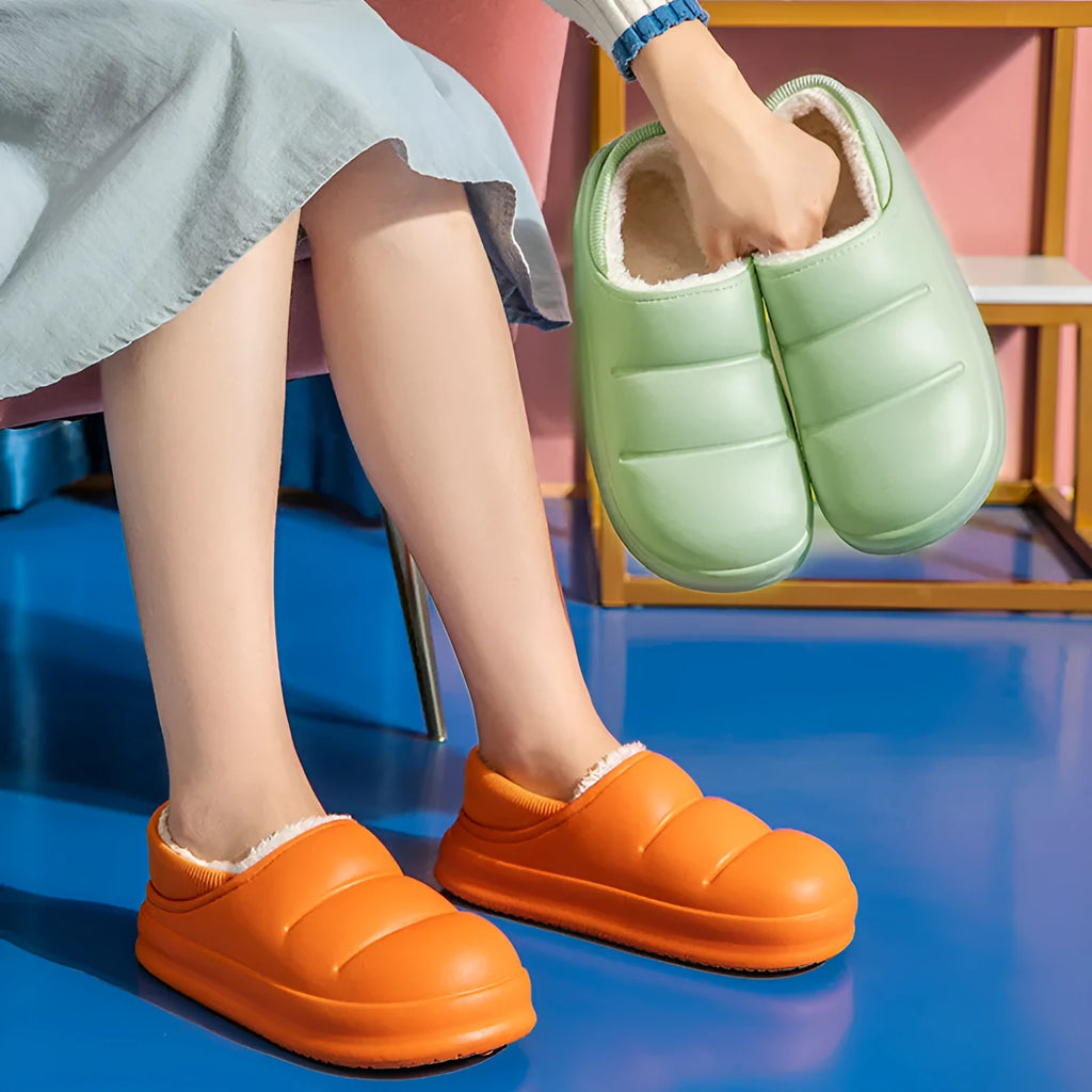 A pair of waterproof EVA garden slippers with a plush lining, shown in a solid colour with a non-slip sole.