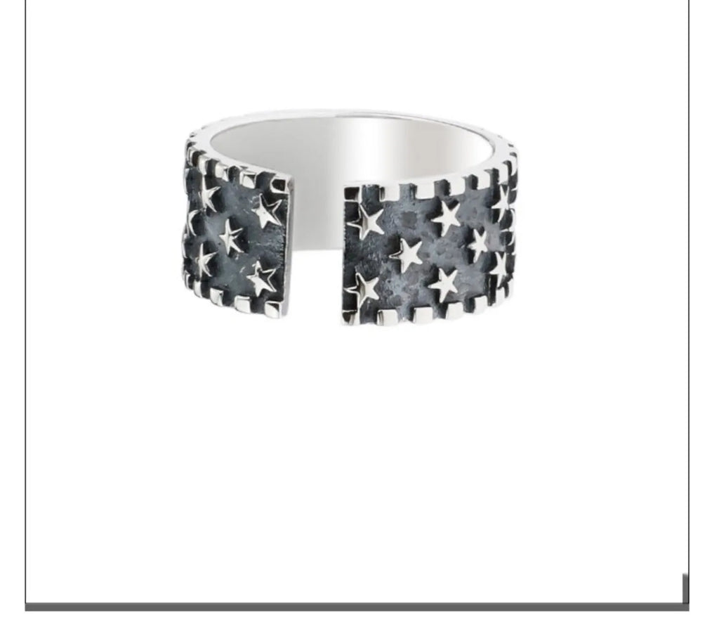 Adjustable open-ended sterling silver ring with a geometric multi five-pointed star pattern.