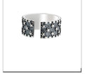 Adjustable open-ended sterling silver ring with a geometric multi five-pointed star pattern.