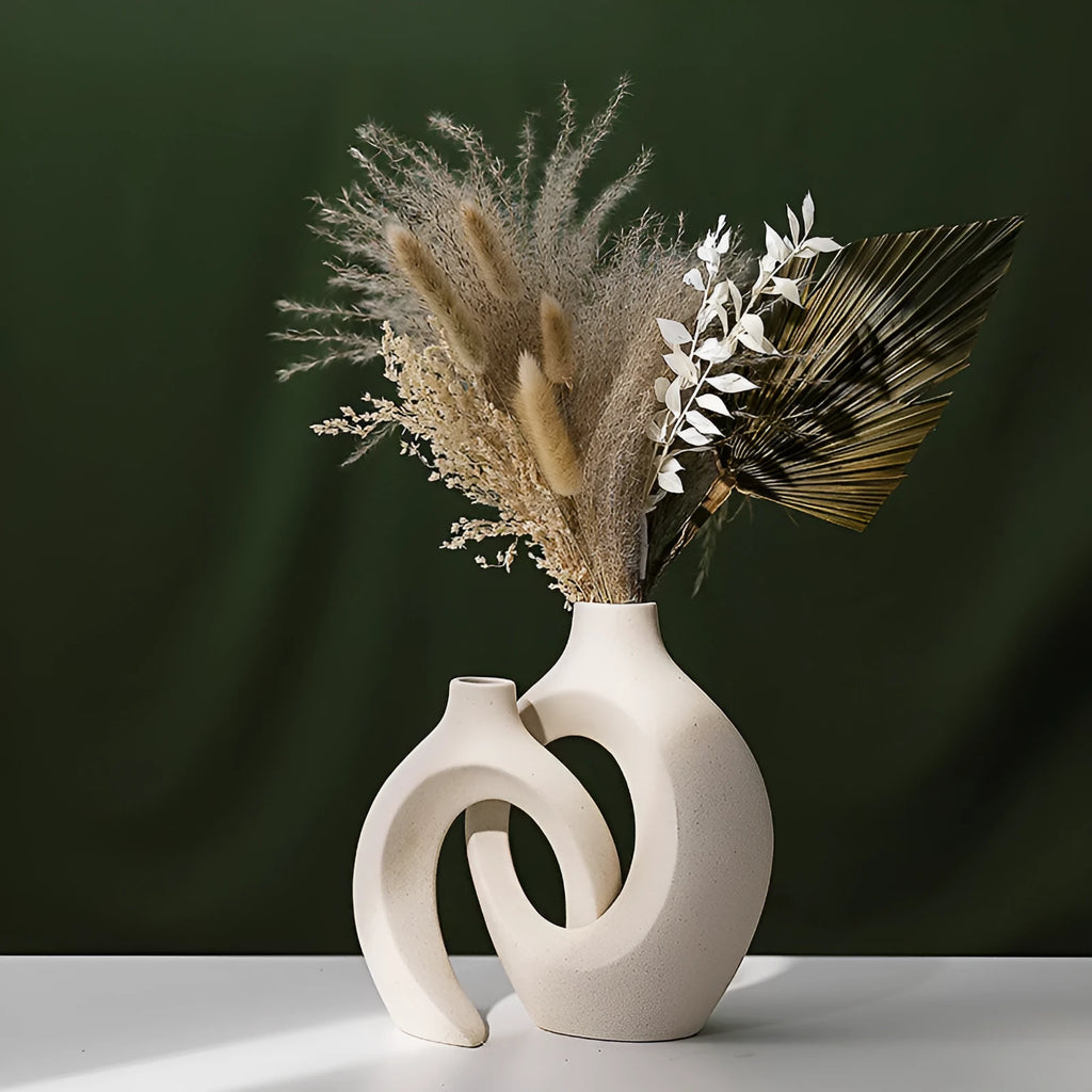 Two European ceramic vases with glazed snuggle colour finish, set on a shelf for creative home decoration