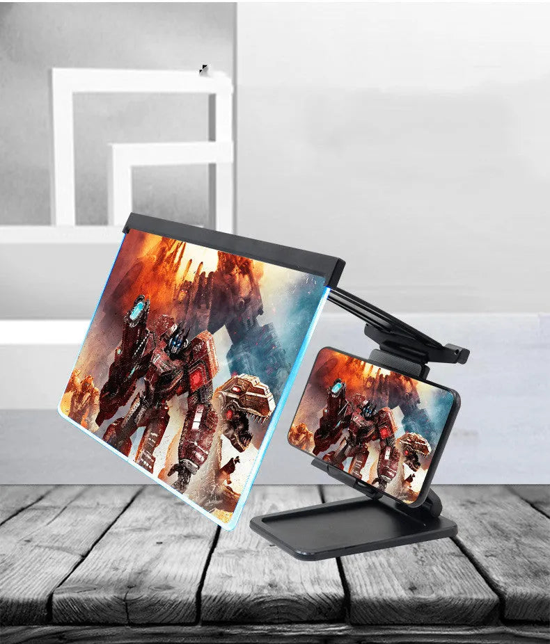 Black foldable mobile phone screen amplifier with a detachable phone holder on a desktop.