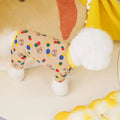 Beige dog t-shirt with a colourful cartoon ball bear design, showing a casual fit on a pet.