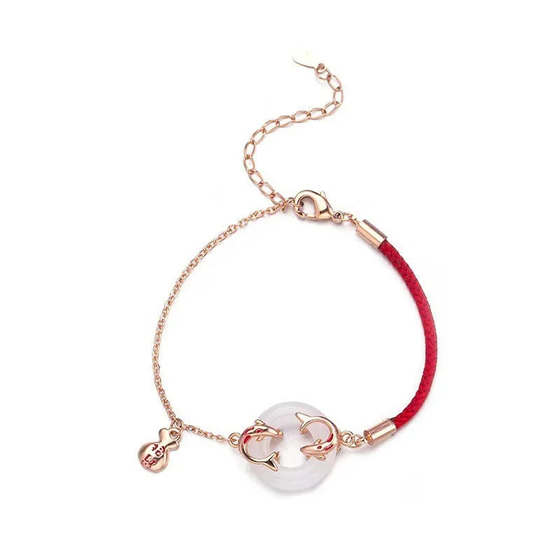 Red rope women's bracelet with peace buckle clasp and festive koi fishtail design