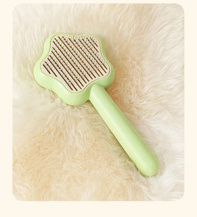 Green self-cleaning cat comb with stainless steel needle teeth and 20 cm handle