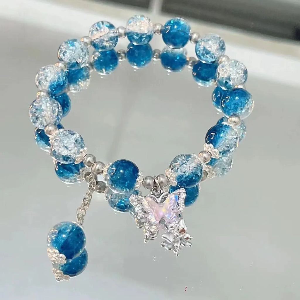 Handmade glass bead bracelet with fairy butterfly broken beads design on white background