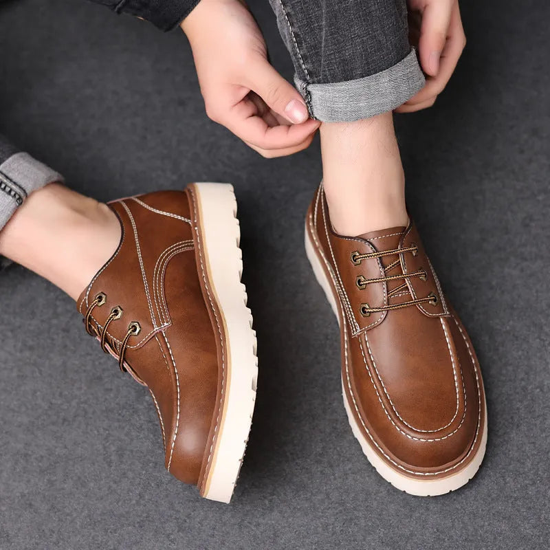 Men's black retro low-top Martin boots with a round toe and rubber sole on a white background