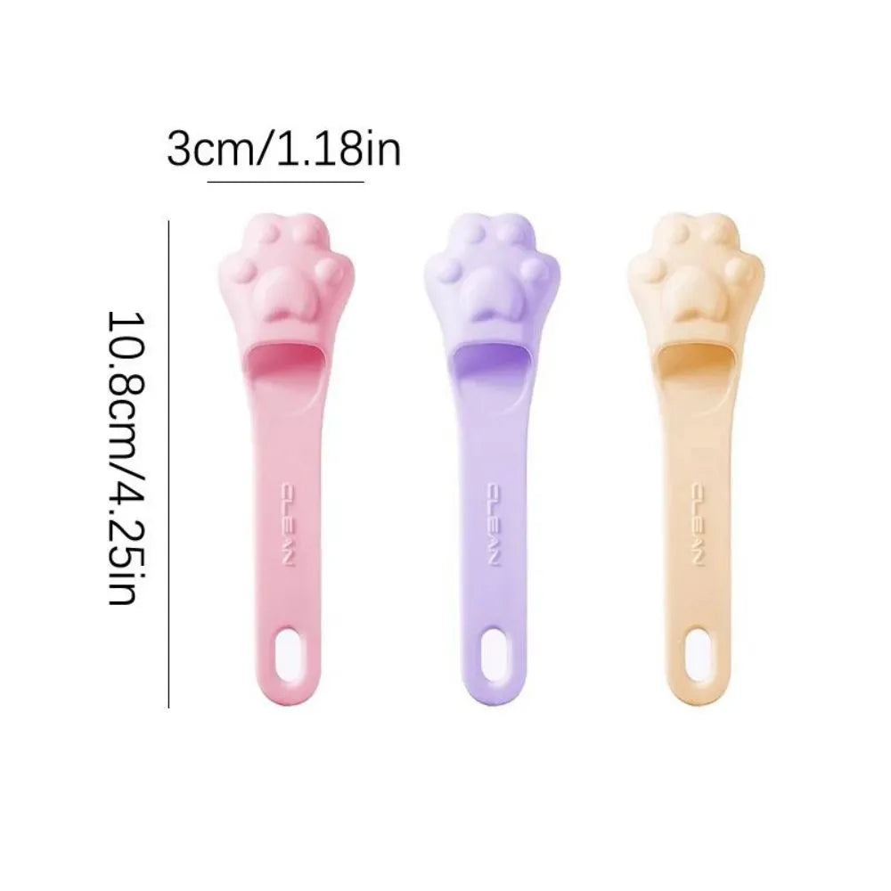 Silicone finger cover toothbrush for dogs and cats in pink, purple, yellow, and white.