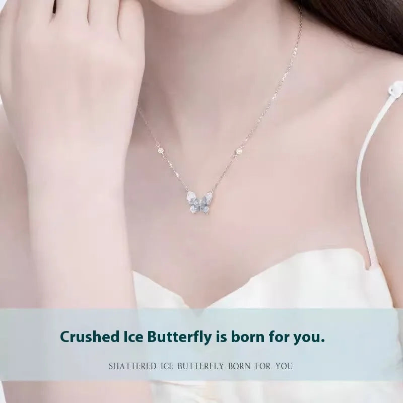 Close-up of a silver necklace with a detailed butterfly pendant on an O-ring chain.