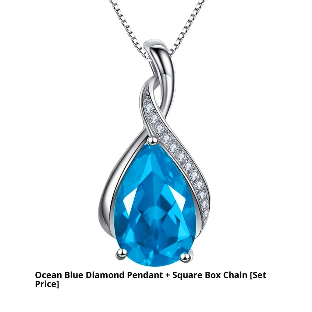 Copper drop shape pendant necklace with electroplated finish on a dark blue diamond square chain